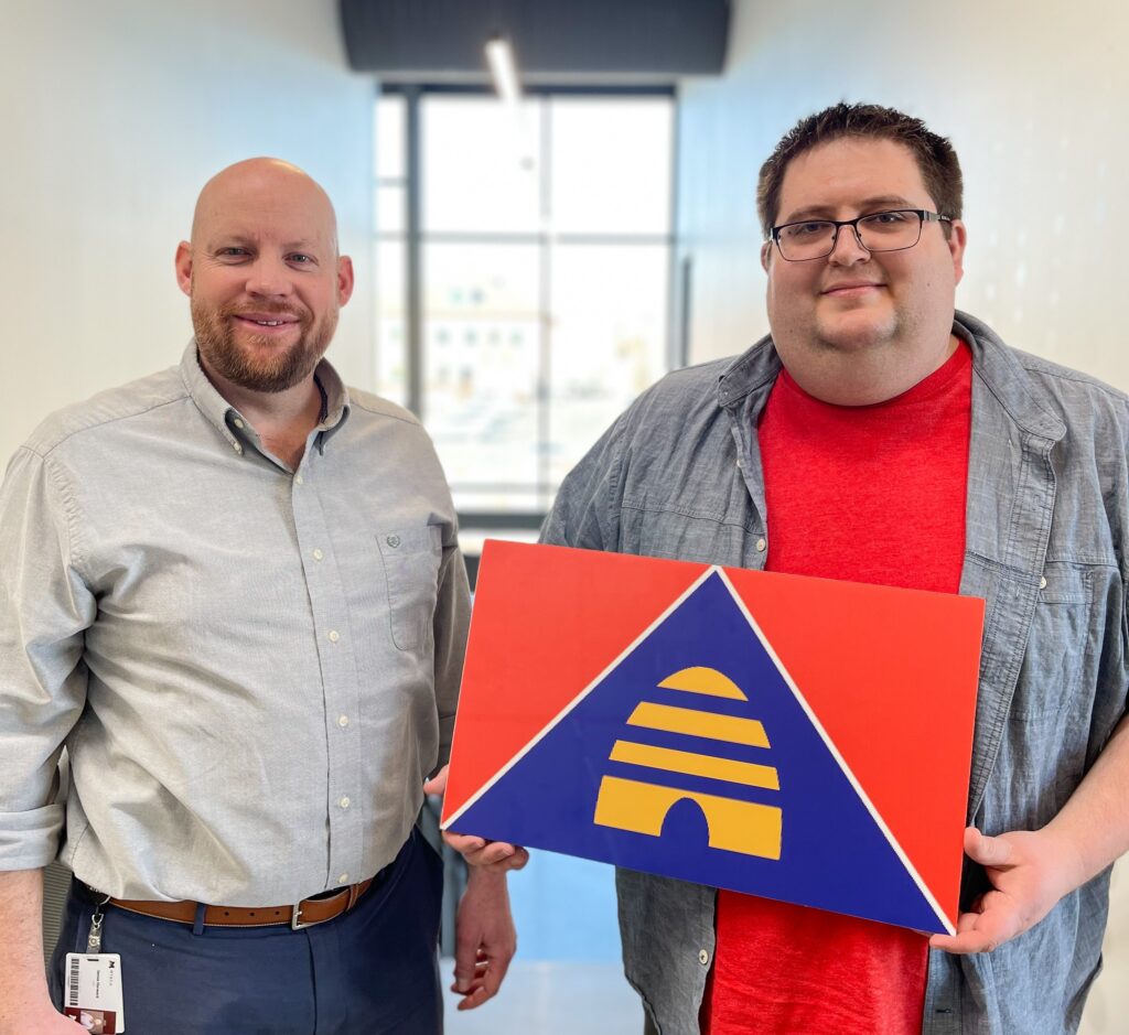 Photo of student Conner Pearson and instructor with his state flag submission