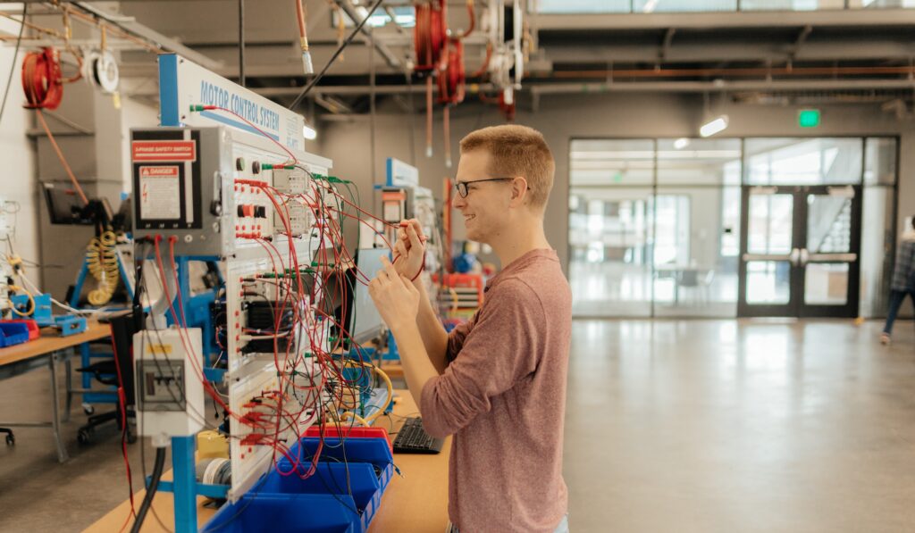 Automated Manufacturing student changing wires on a board