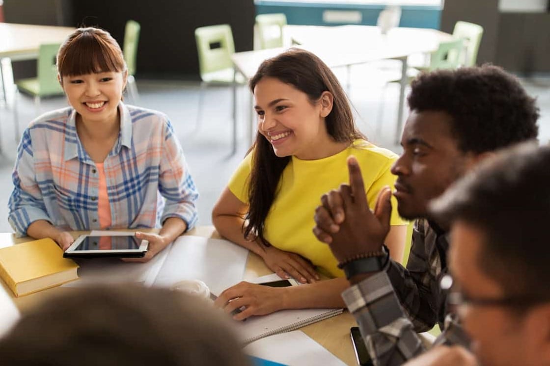 stock images of young people talking at a table