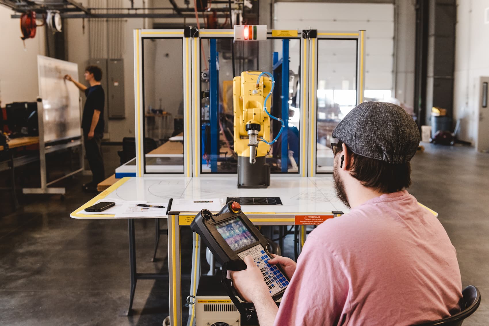 A student operating a robotic arm