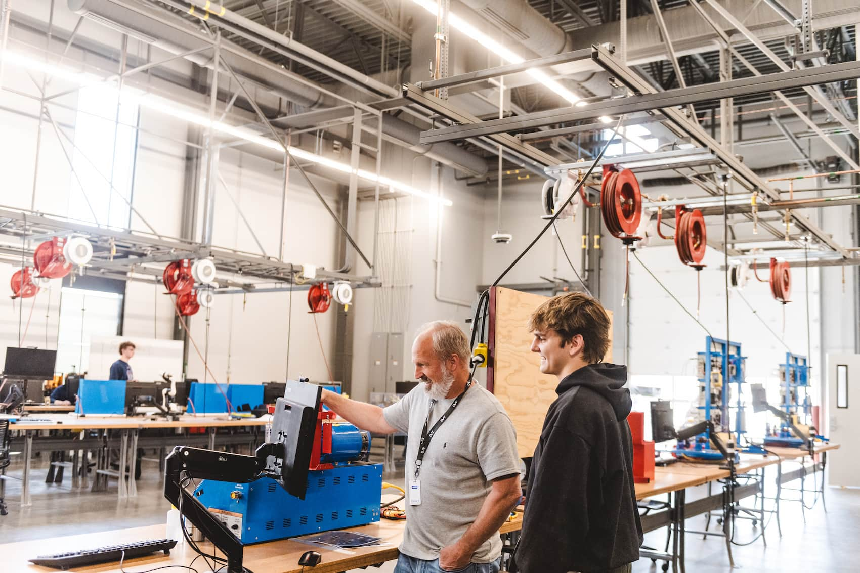 Instructor showing a student some automation equiment