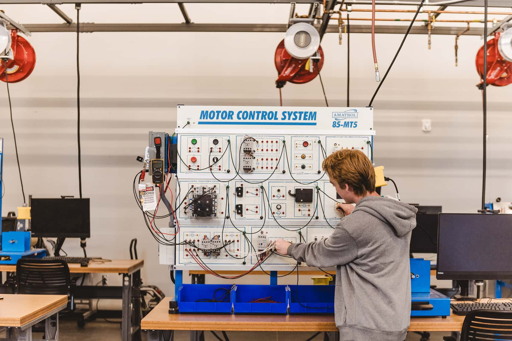 A student operating a motor control system