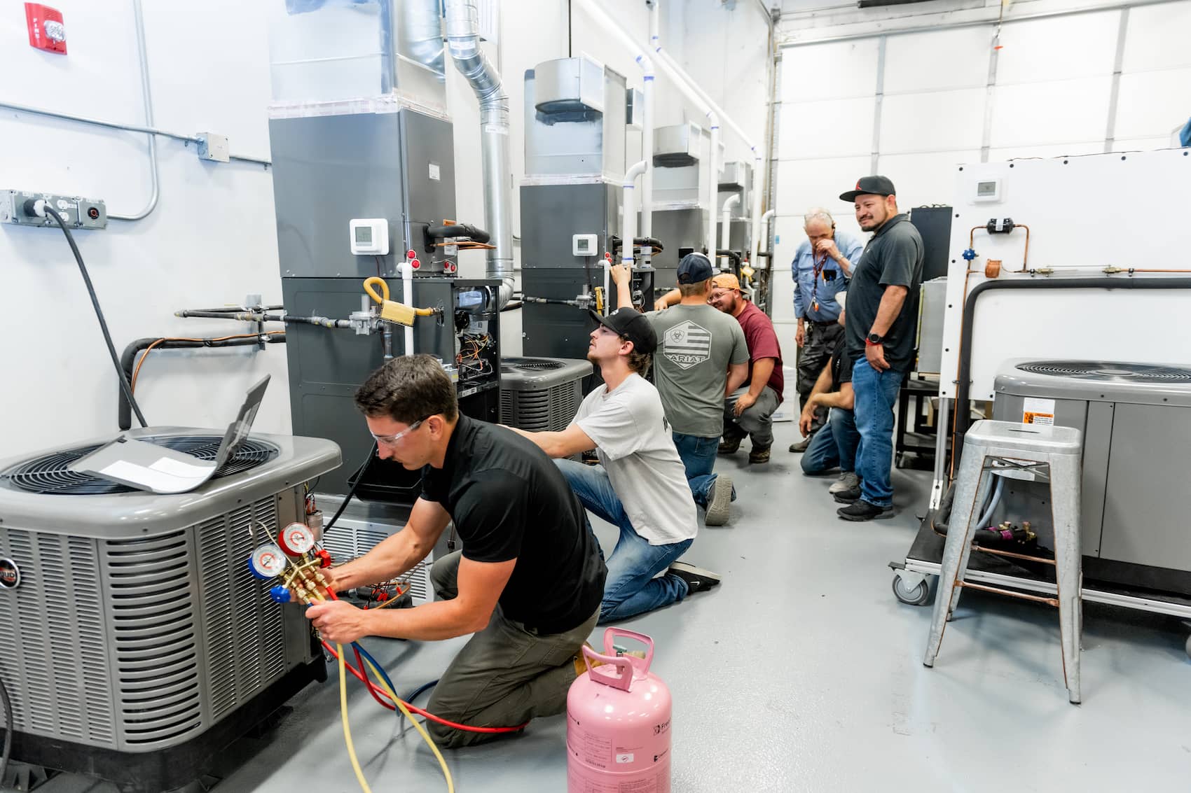 Five students working on AC and heater units