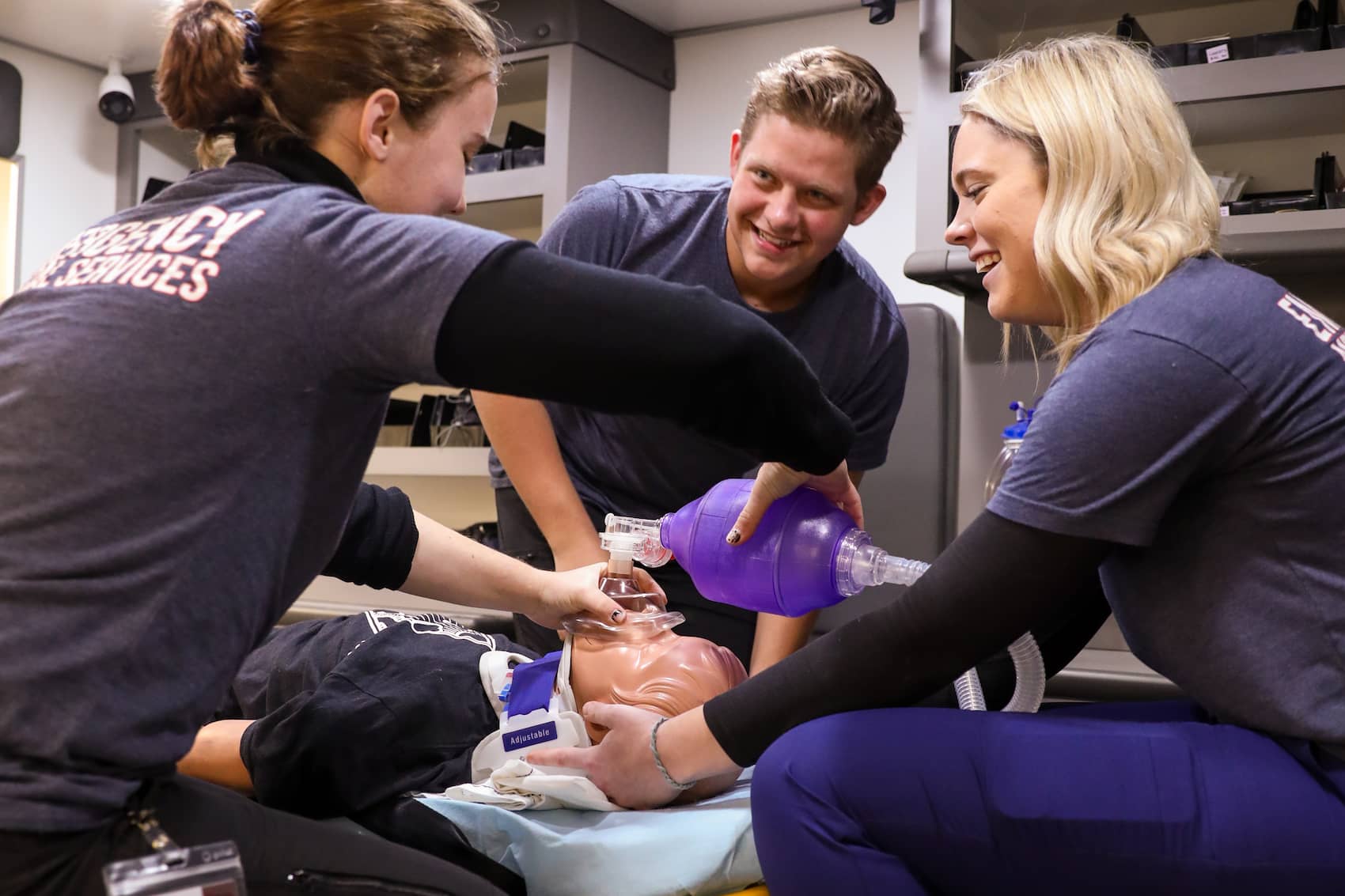 Students practicing resuscitation in a mock ambulance