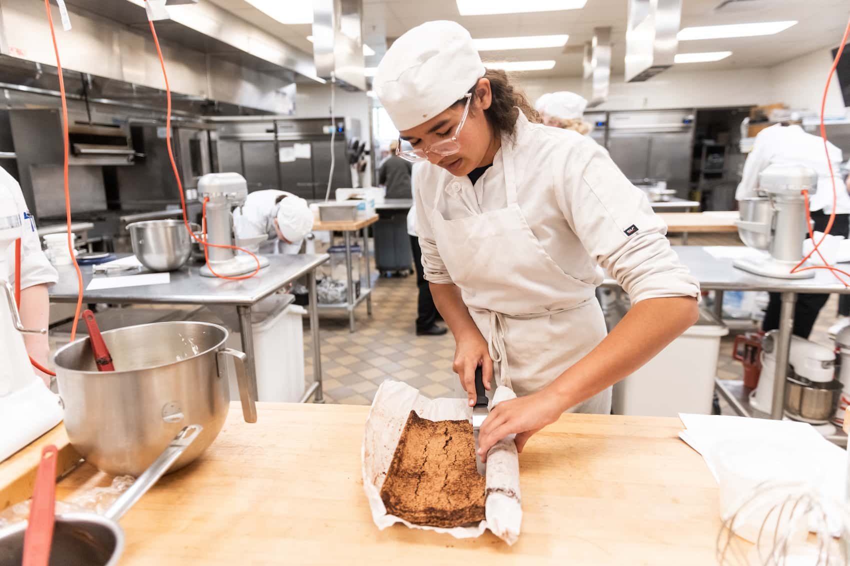 Student rolling a pastry