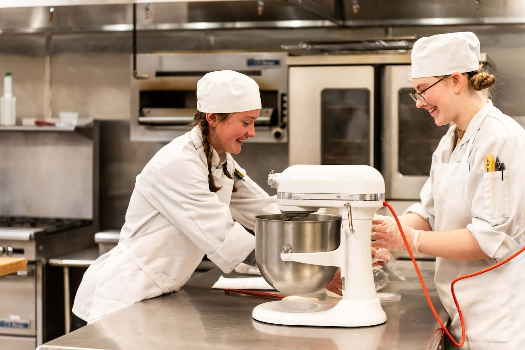 Two culinary students preparing a recipe