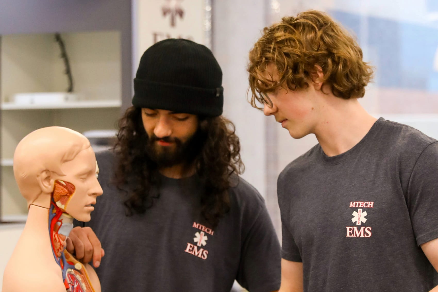 Students looking into the abdomen of a manikin