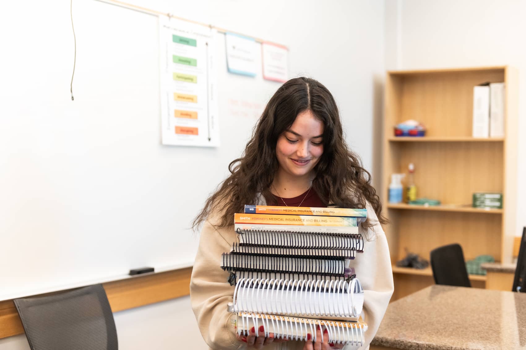 Student carrying nine books