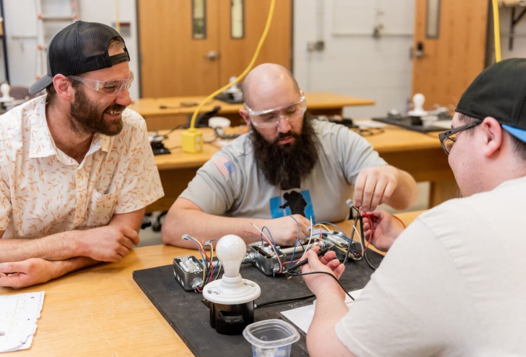 Electrical apprenticeship students testing wires